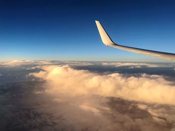 Aerial view of clouds over landscape seen from airplane