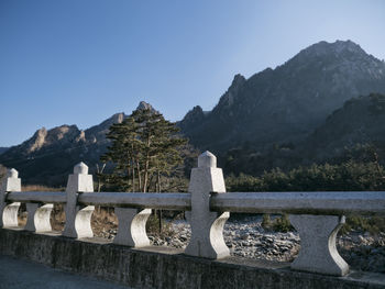 Gazebo by mountains against clear sky