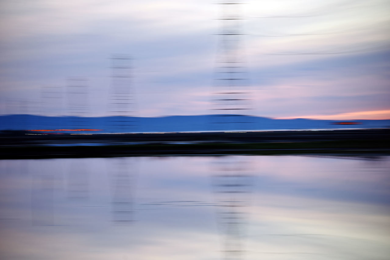 reflection, cloud, sky, water, blue, horizon, nature, beauty in nature, scenics - nature, tranquility, dawn, no people, morning, sunlight, tranquil scene, lake, sunrise, light, blurred motion, outdoors, wave, idyllic, motion, waterfront, landscape, day