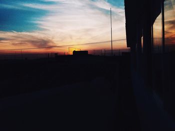 Silhouette of built structure at sunset