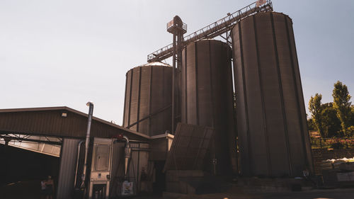 Low angle view of factory against clear sky