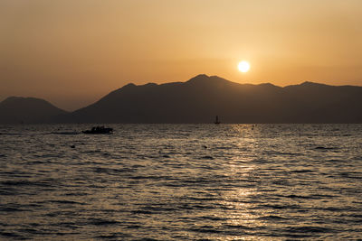 Scenic view of sea against orange sky