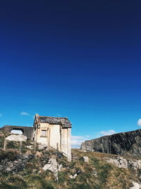 Abandoned building against clear blue sky