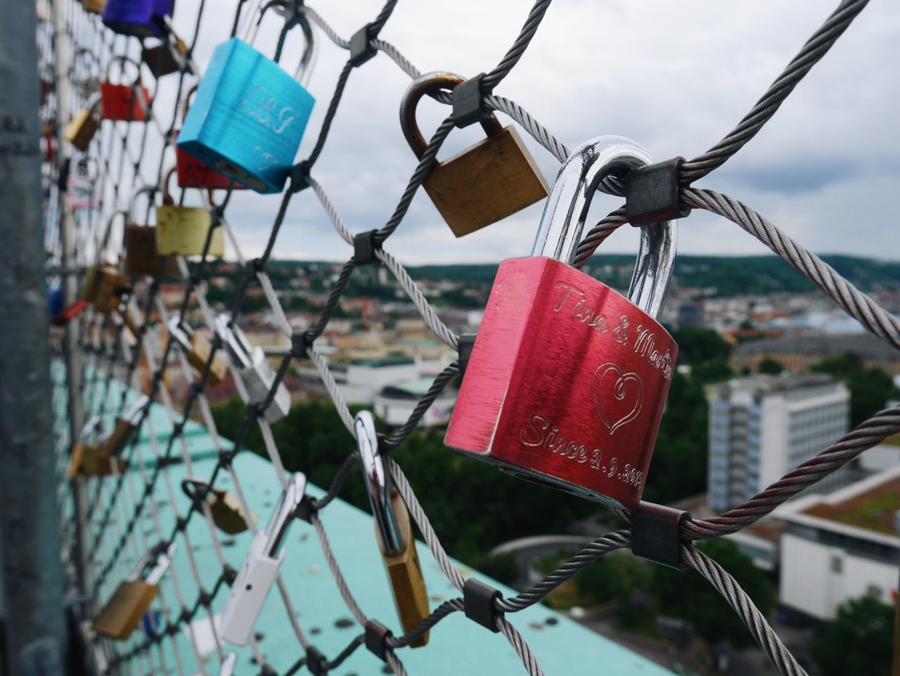 hanging, security, padlock, love, safety, protection, love lock, lock, text, hope - concept, metal, luck, heart shape, hope, no people, day, close-up, red, cultures, railing, outdoors, focus on foreground, water, sky