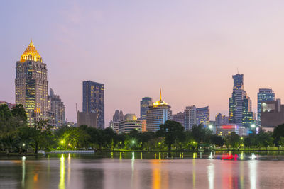 Illuminated buildings in city against sky