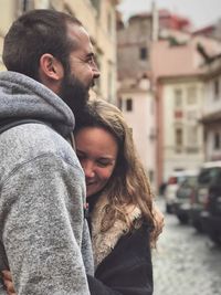 Smiling young couple on street in city