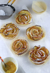 Homemade apple roses with puff pastry .