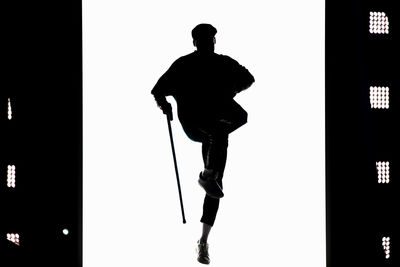 Rear view of silhouette man walking against clear sky