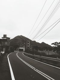 Road by mountain against clear sky