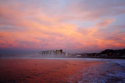 Scenic view of beach against sky during sunset