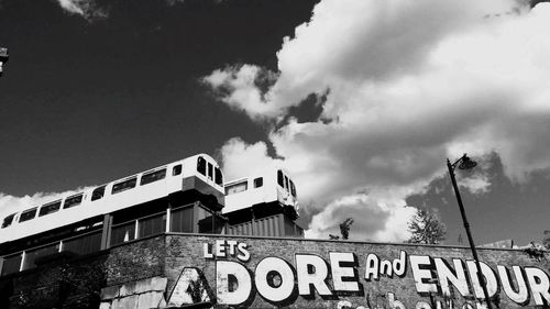 Low angle view of building against cloudy sky