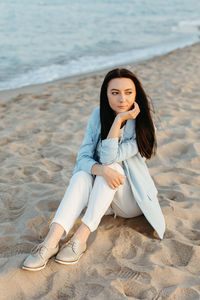 Beautiful girl relaxing on the beach at sunset in catania, italy