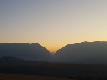 Scenic view of silhouette mountains against clear sky