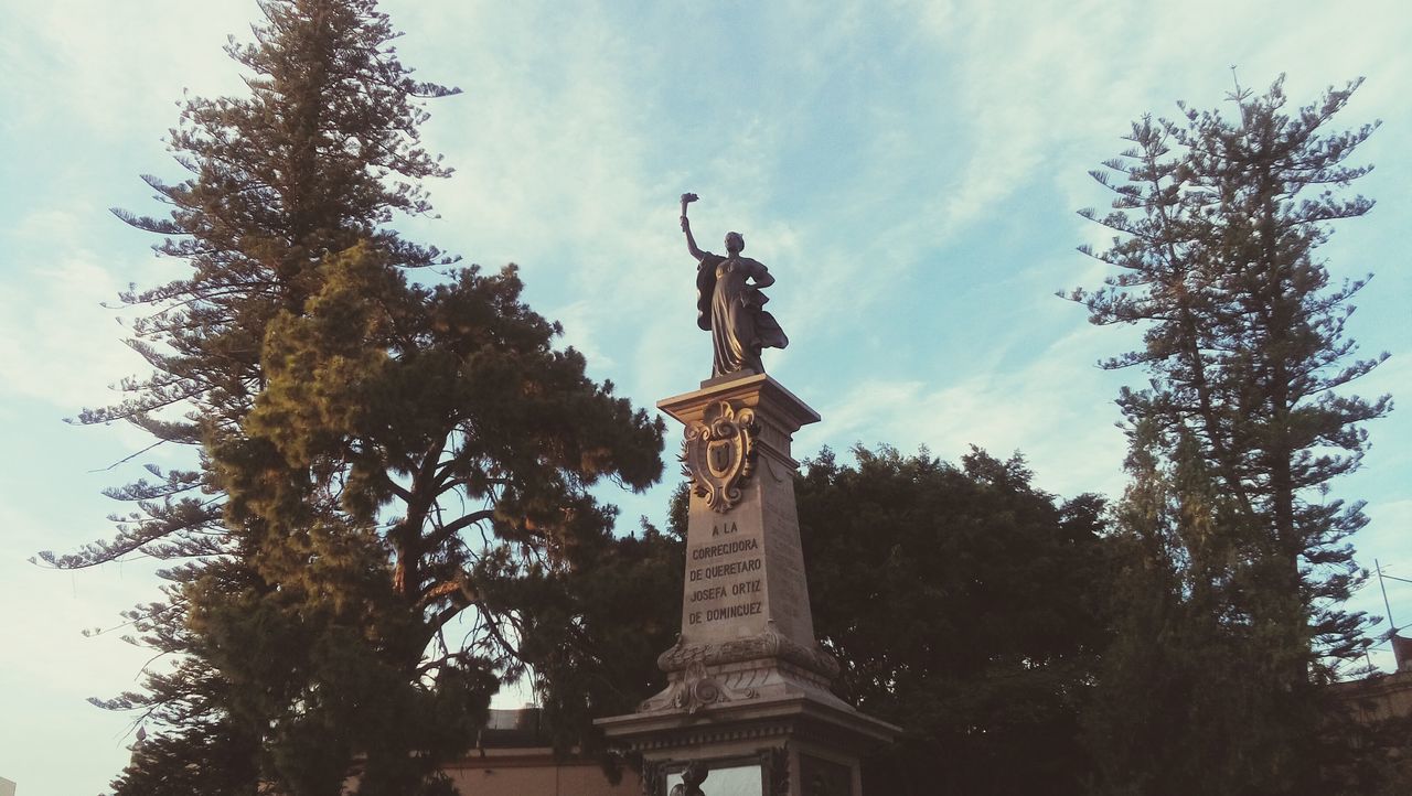 statue, sky, tree, low angle view, sculpture, no people, outdoors, architecture, cloud - sky, day