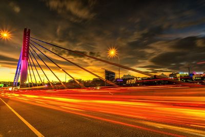 Light trails on road against sky at night