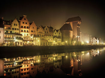 Reflection of illuminated buildings on canal at night