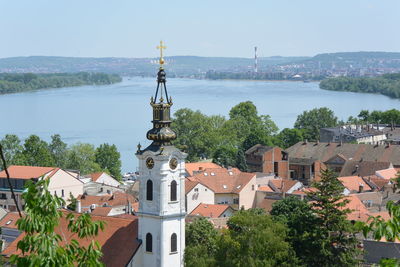 Panoramic view of buildings and trees against sky