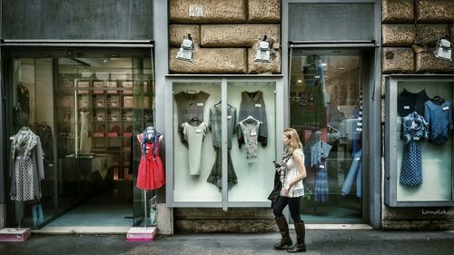 Woman standing by window in store