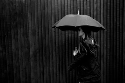 Woman standing with umbrella