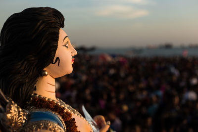 Close-up of woman looking at sunset