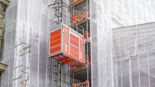 Low angle view of construction site against building