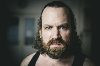 Portrait of angry man standing indoors