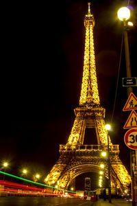 Low angle view of illuminated buildings against sky at night