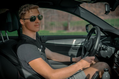 Portrait of man sitting in car