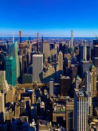 Aerial view of buildings against clear sky