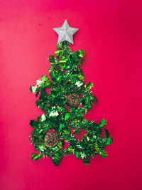 Christmas tree against red wall
