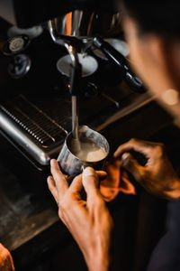 Cropped hand of man working in cafe