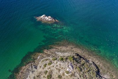 High angle view of rocks in sea