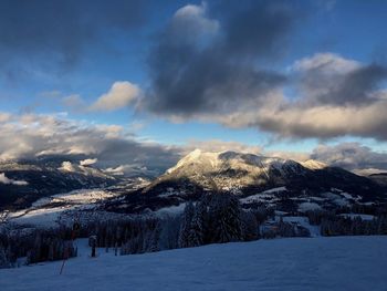 Scenic view of snow covered mountains against sky