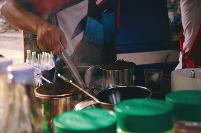 Midsection of man preparing food in kitchen