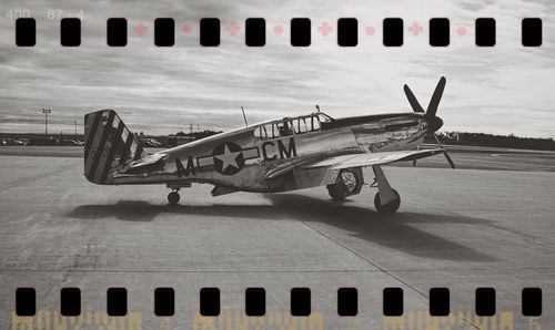 Airplane on runway against sky