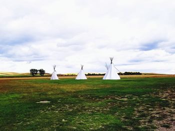 Built structure on field against sky