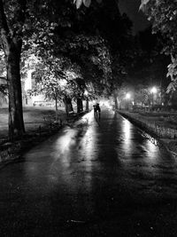 Man walking on road in city at night
