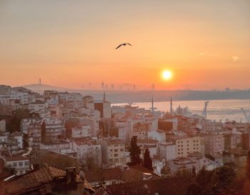 Aerial view of cityscape against sky during sunset