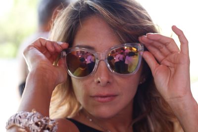 Close-up portrait of young woman wearing sunglasses