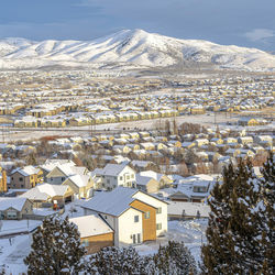 High angle view of snow covered houses in city