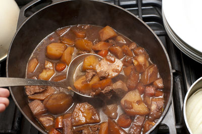 Close-up of beef stew in container on burner