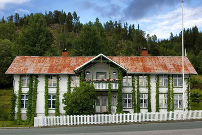 House by trees against sky
