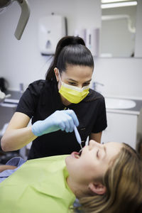 Female dentist with patient in office