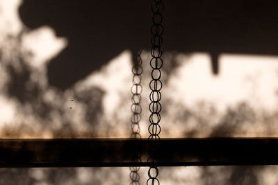 Close-up of metal structure against sky