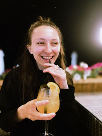 Portrait of young woman having drink