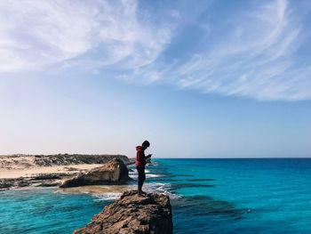 Man looking at sea against sky