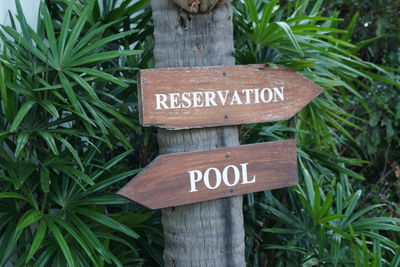 Close-up of sign board by plants