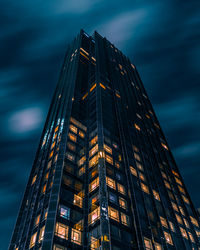 Low angle view of illuminated buildings against sky at dusk