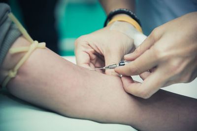 Cropped image of doctor injecting patient