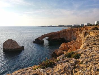 Rocks on shore against sky